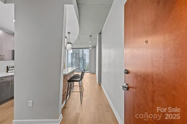 a view of a hallway with wooden floor and staircase