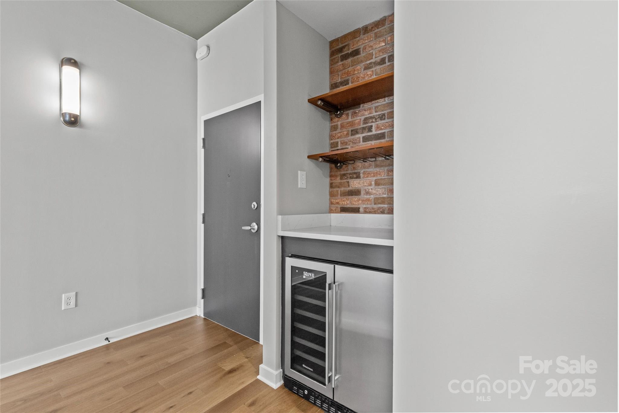210 North Church Street, Unit 2910 Charlotte, NC 28202 - Photo 6 of 30 a kitchen view with wooden floor and electronic appliances