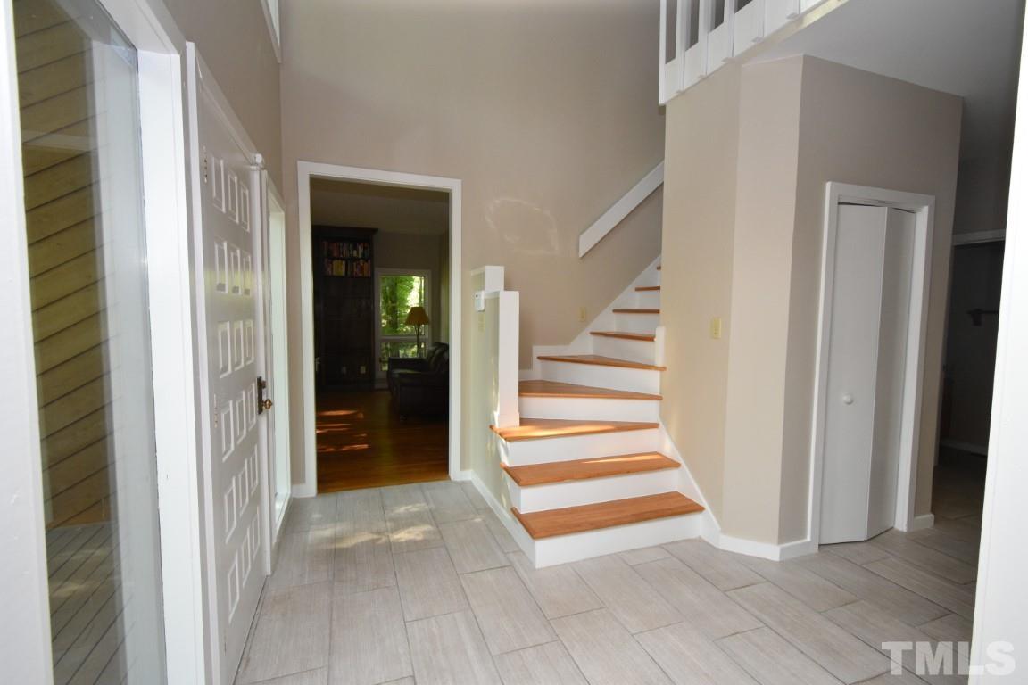 408 Constitution Drive Durham, NC 27705 - Photo 11 of 39 a view of a hallway with wooden floor and entryway