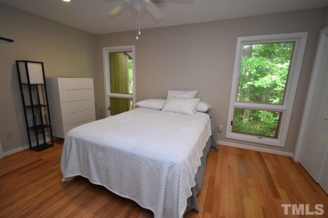 408 Constitution Drive Durham, NC 27705 - Photo 20 of 39 a bedroom with a bed and a large window