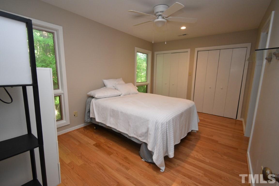 408 Constitution Drive Durham, NC 27705 - Photo 21 of 39 a bedroom with a bed and a large mirror
