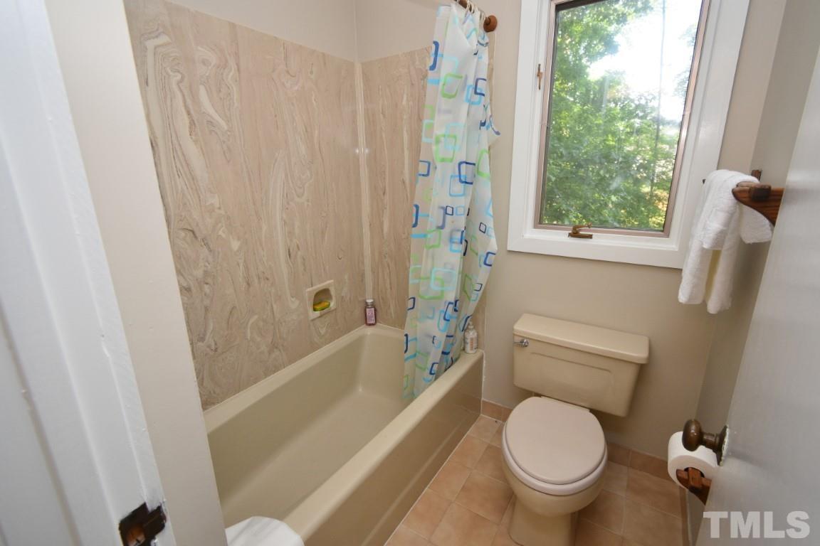 408 Constitution Drive Durham, NC 27705 - Photo 22 of 39 a bathroom with a toilet and a bathtub
