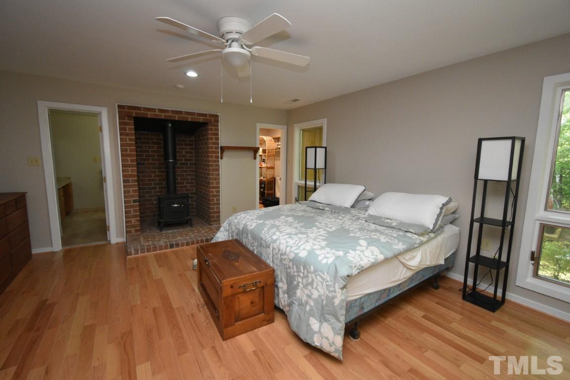 408 Constitution Drive Durham, NC 27705 - Photo 29 of 39 a spacious bedroom with a bed and a chandelier