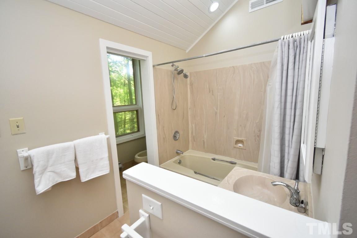 408 Constitution Drive Durham, NC 27705 - Photo 30 of 39 a bathroom with a tub and a sink
