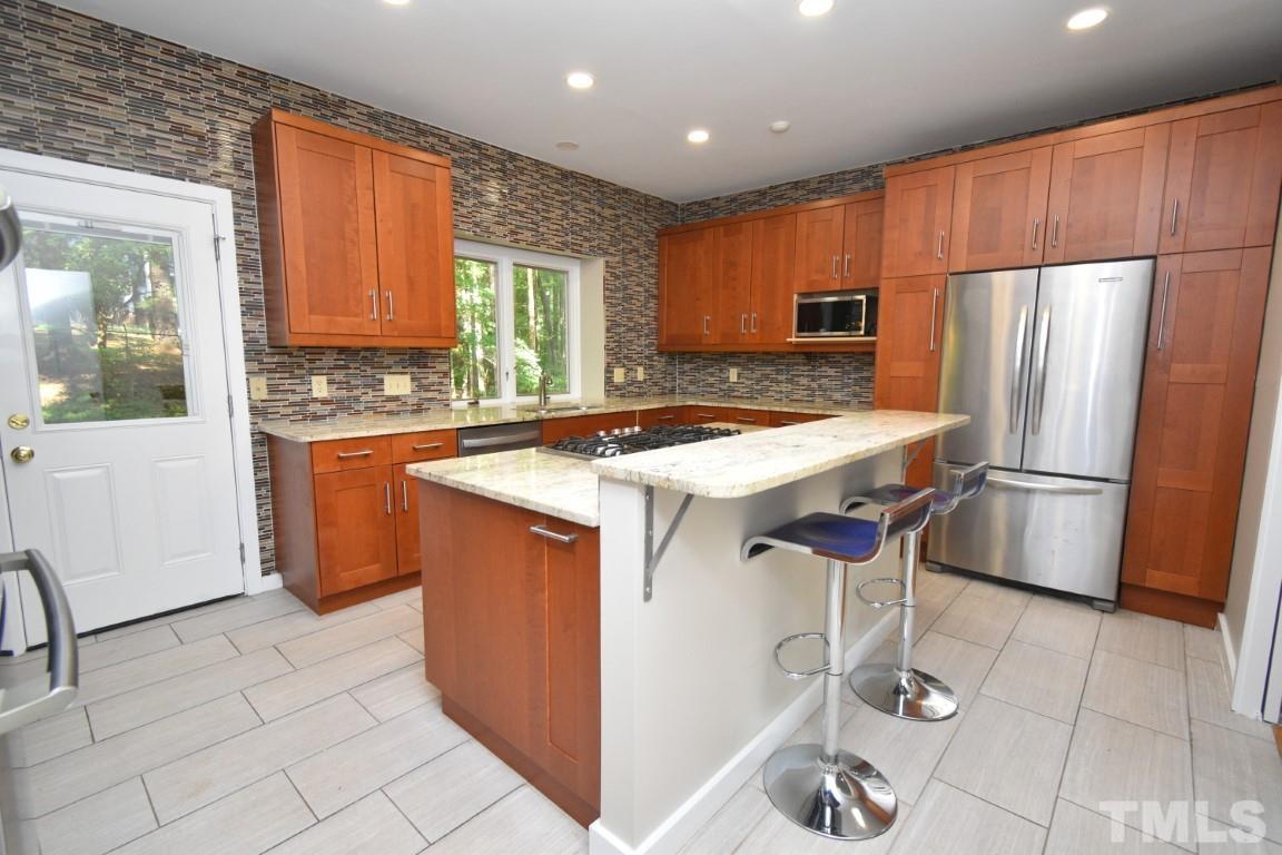 408 Constitution Drive Durham, NC 27705 - Photo 7 of 39 a kitchen with granite countertop a sink appliances a counter space and cabinets