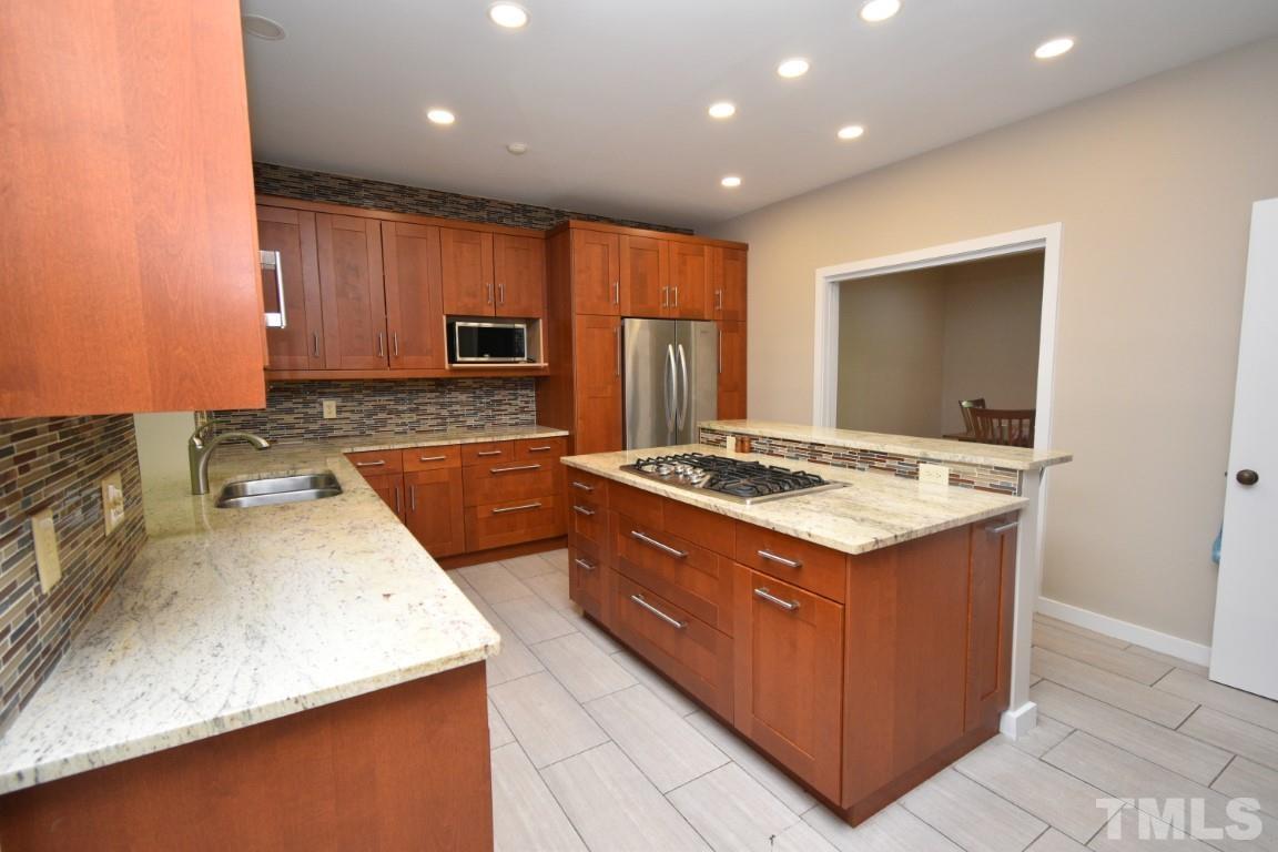 408 Constitution Drive Durham, NC 27705 - Photo 8 of 39 a kitchen with a stove sink and cabinets