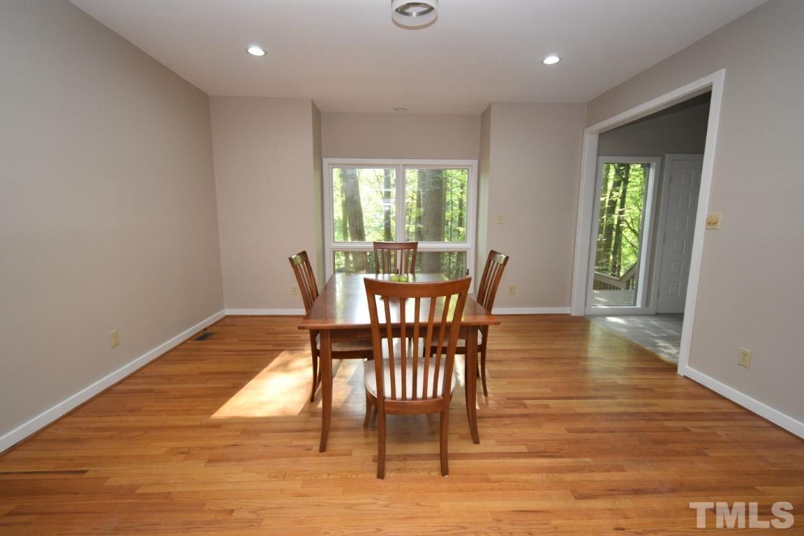 408 Constitution Drive Durham, NC 27705 - Photo 9 of 39 a view of a dining room with furniture window and wooden floor