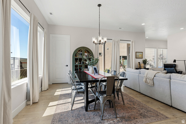 839 Walker Way St. George, UT 84770 - Photo 8 of 32 Dining area featuring light wood-finish flooring and a contemporary chandelier