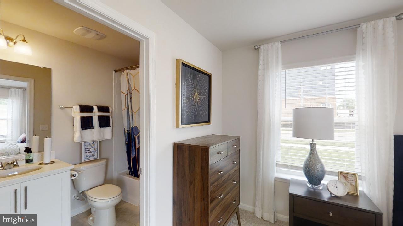 2113 Ruby Turn Bowie, MD 20721 - Photo 41 of 48 a bathroom with a toilet sink and mirror