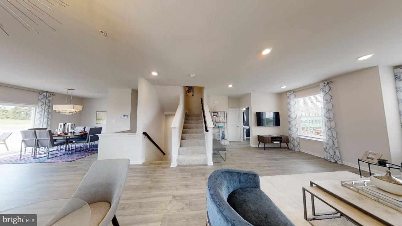 2113 Ruby Turn Bowie, MD 20721 - Photo 48 of 48 a living room with couches and kitchen view with wooden floor