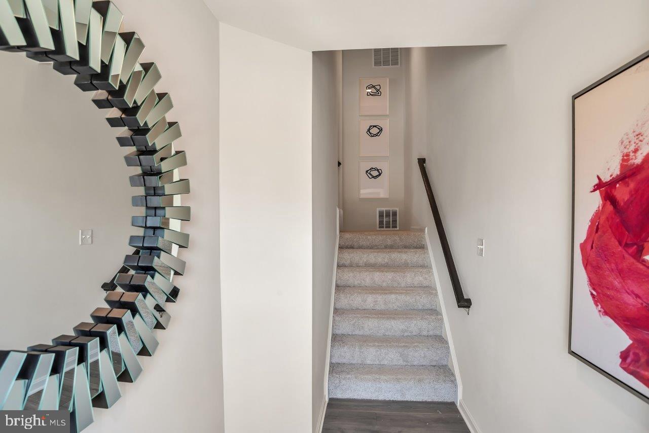 2113 Ruby Turn Bowie, MD 20721 - Photo 8 of 48 a view of a hallway with stairs and wooden floor