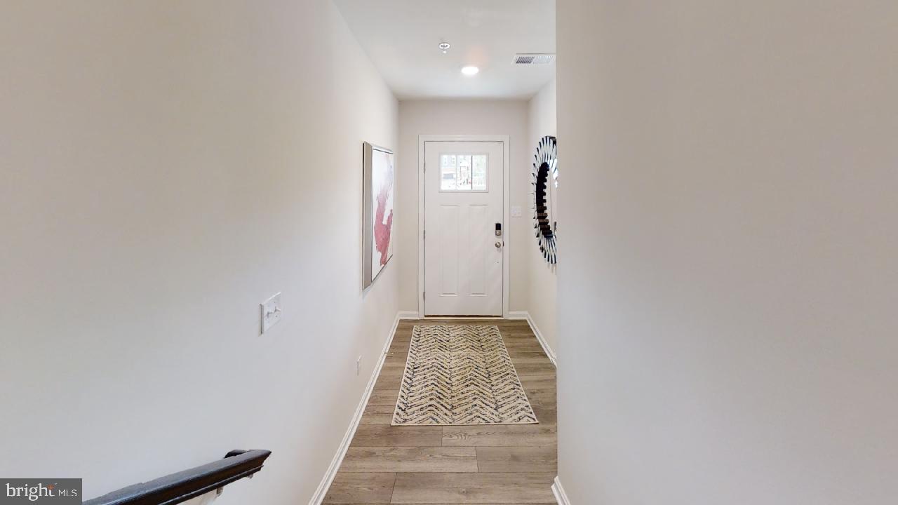 2113 Ruby Turn Bowie, MD 20721 - Photo 9 of 48 a view of a hallway with wooden floor and a bathroom