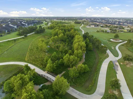 an aerial view of a house with a yard and lake view