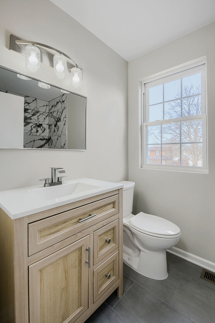 141 Timberlane Road Matteson, IL 60443 - Photo 24 of 27 a bathroom with a granite countertop toilet sink and mirror
