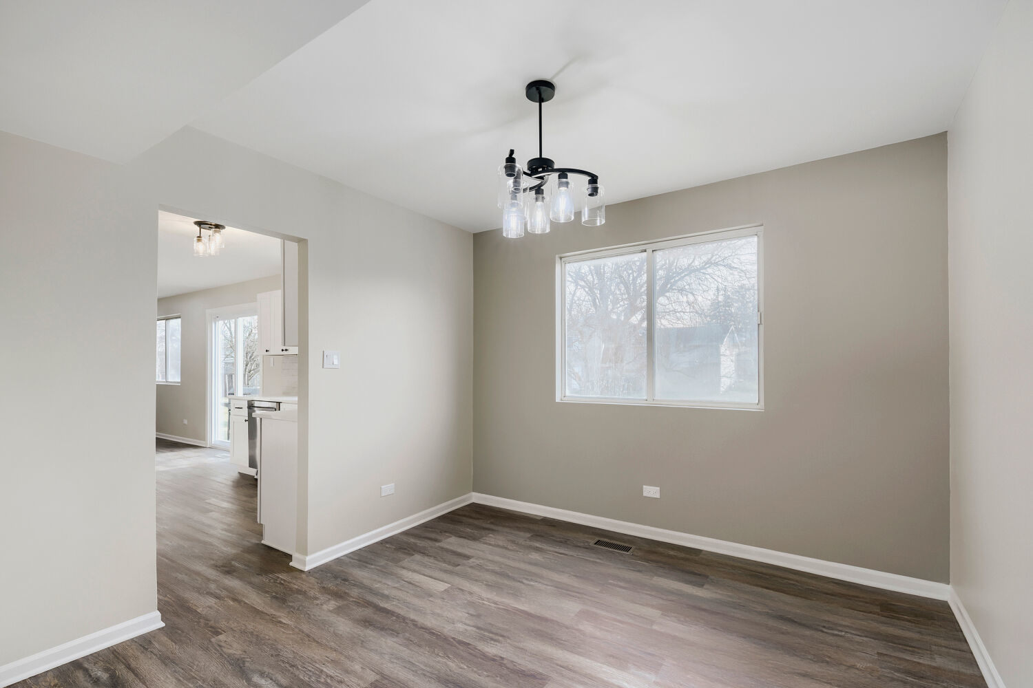 141 Timberlane Road Matteson, IL 60443 - Photo 5 of 27 a view of an empty room with wooden floor and a window