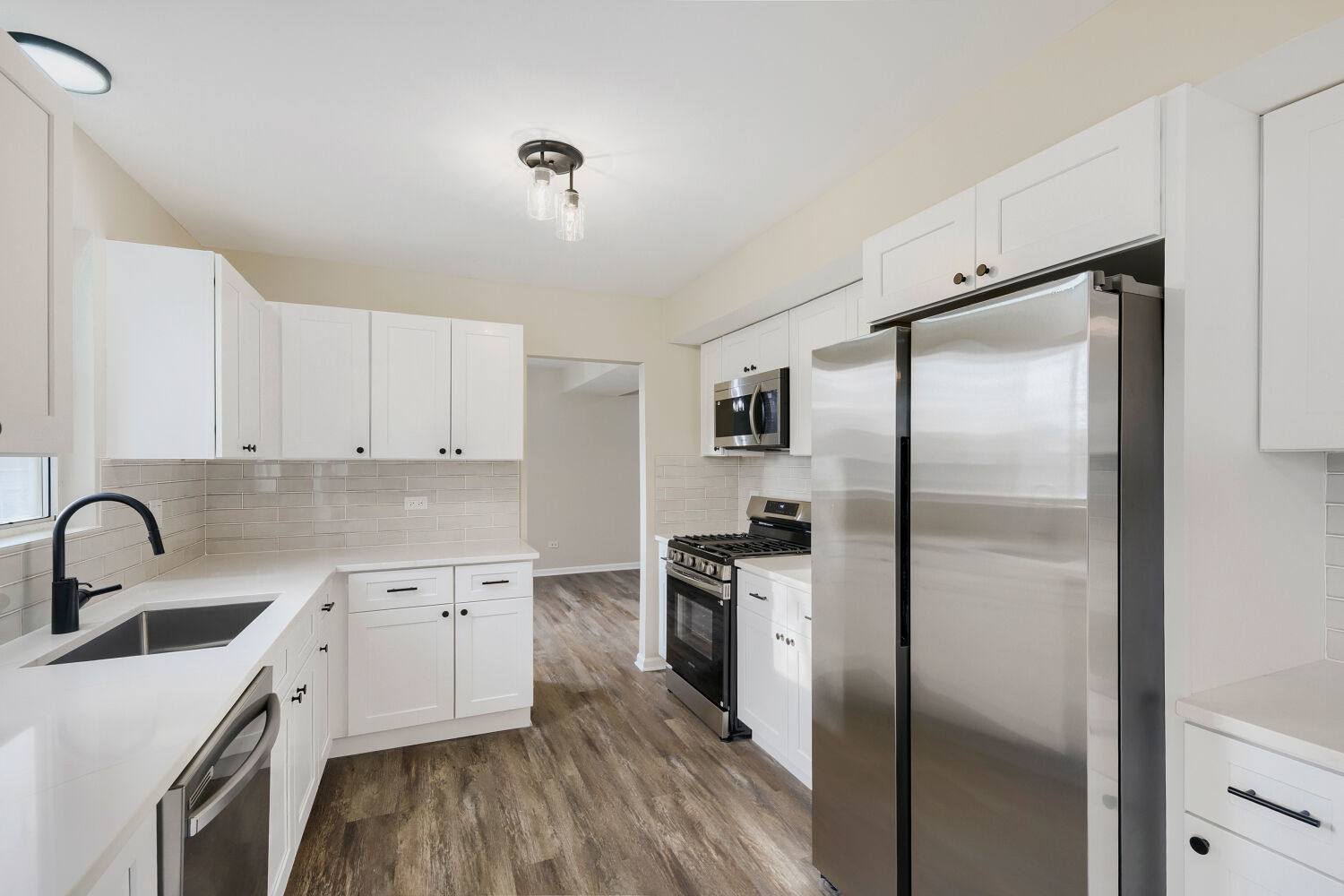 141 Timberlane Road Matteson, IL 60443 - Photo 8 of 27 a kitchen with a refrigerator sink and cabinets