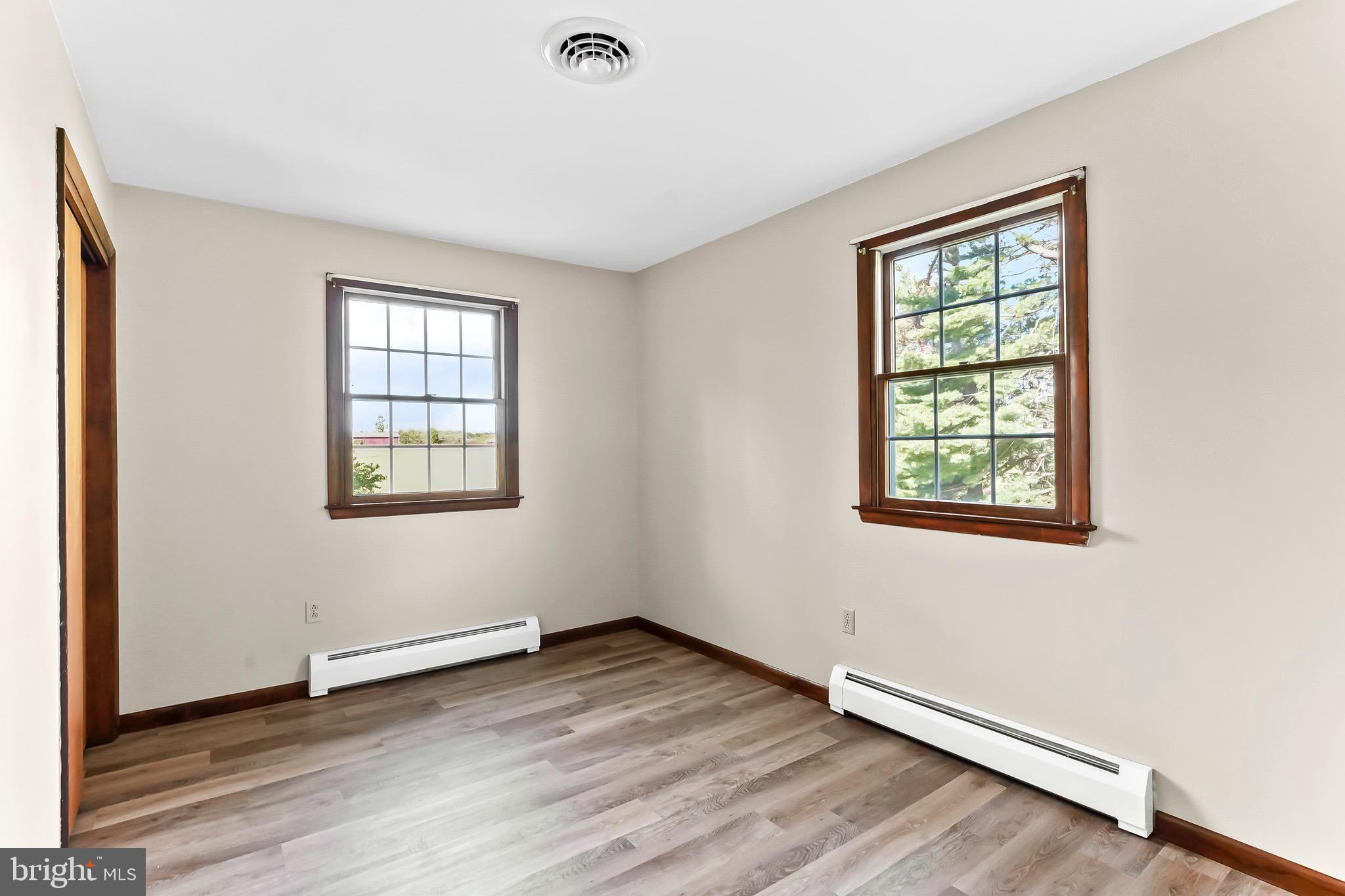350 Roneys Corner Road Oxford, PA 19363 - Photo 12 of 18 an empty room with wooden floor and windows