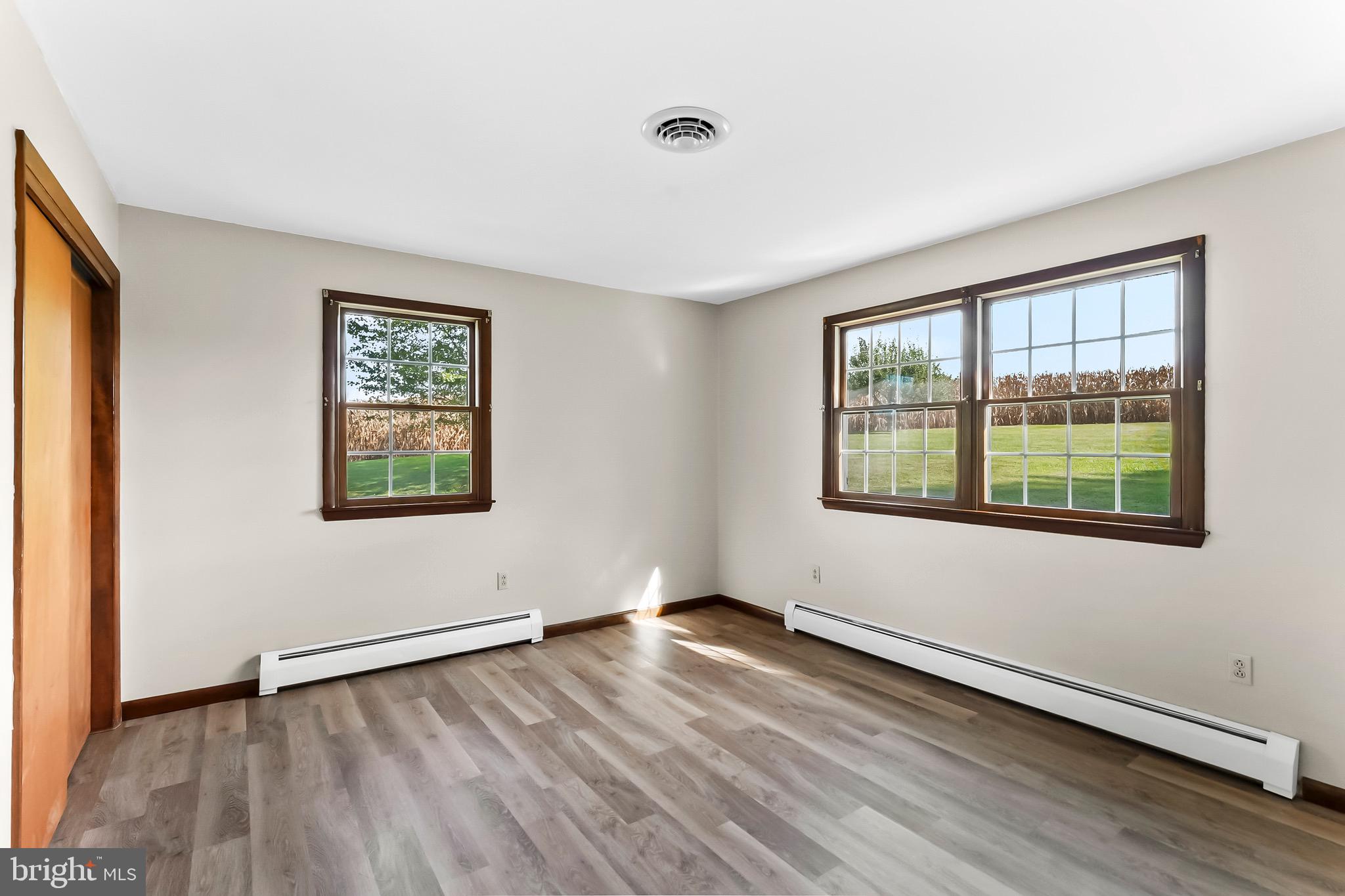 350 Roneys Corner Road Oxford, PA 19363 - Photo 13 of 18 a view of an empty room with wooden floor and a window