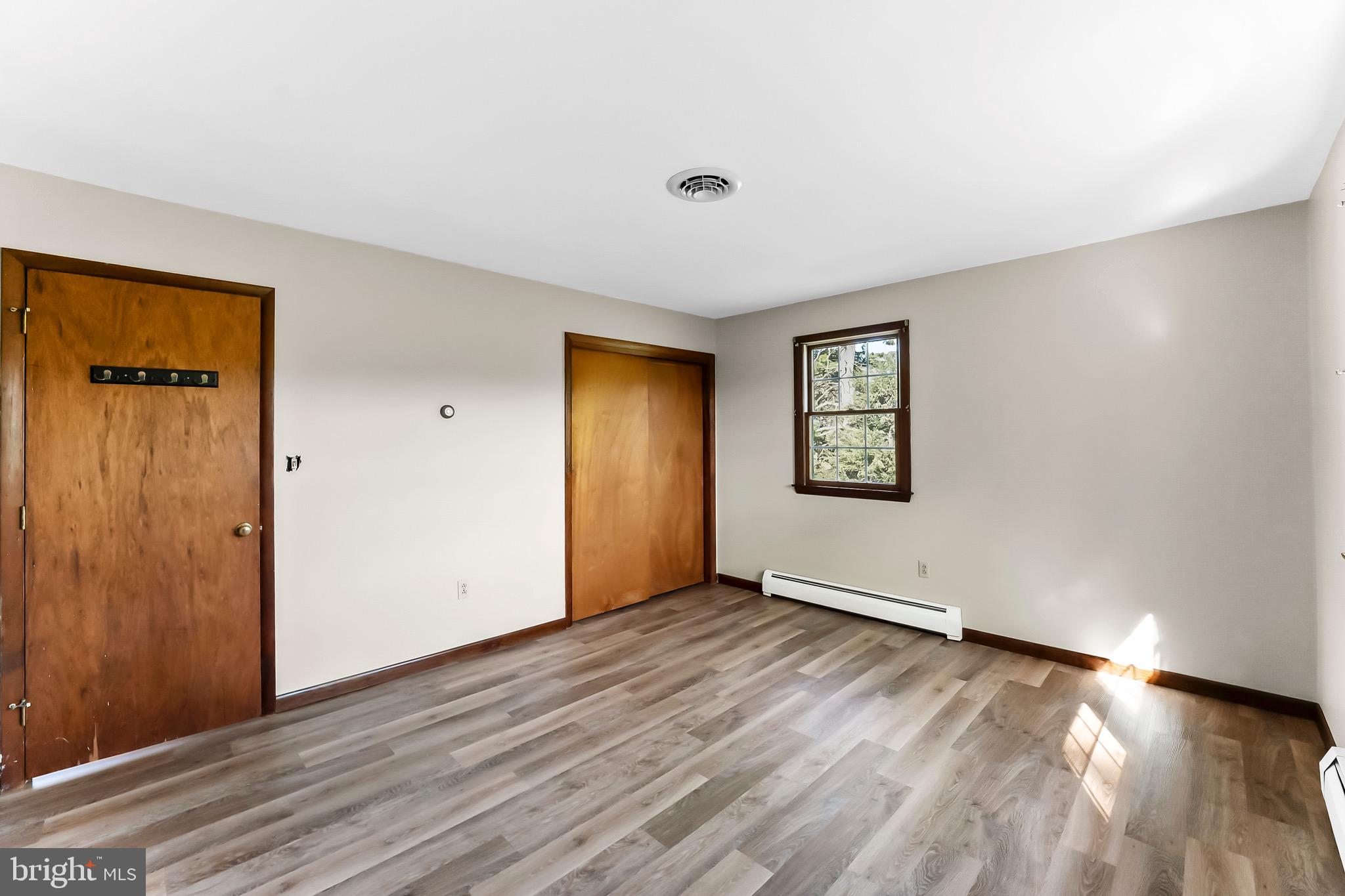 350 Roneys Corner Road Oxford, PA 19363 - Photo 14 of 18 an empty room with wooden floor and windows