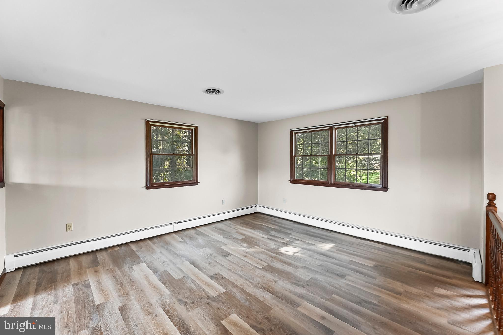 350 Roneys Corner Road Oxford, PA 19363 - Photo 5 of 18 an empty room with wooden floor and windows