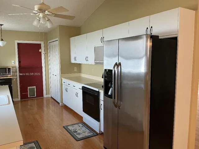 a kitchen with stainless steel appliances a refrigerator and a sink