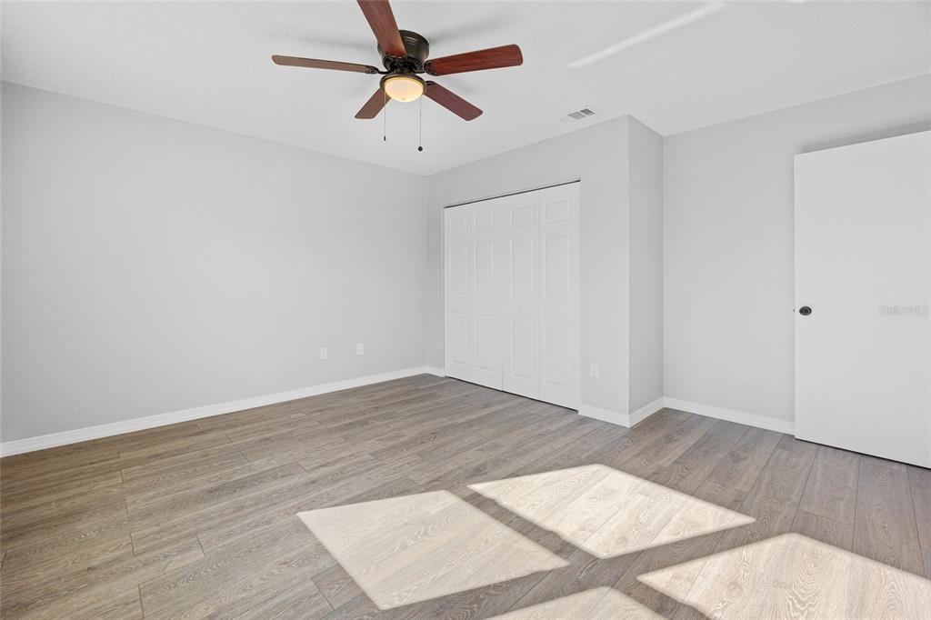 2 Oak Court Pass Ocala, FL 34472 - Photo 13 of 28 a view of a big room with wooden floor and a ceiling fan