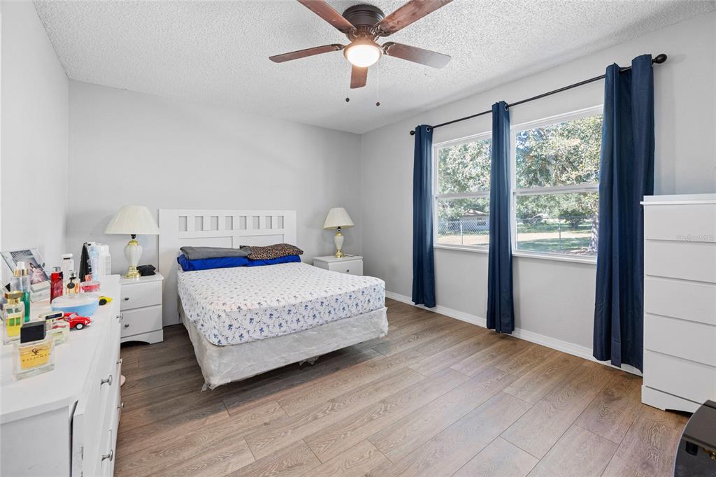 2 Oak Court Pass Ocala, FL 34472 - Photo 15 of 28 a bedroom with a bed and a chandelier