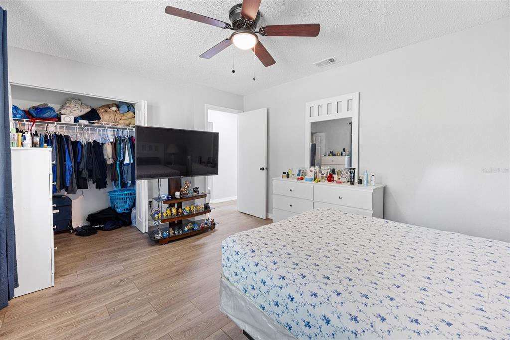 2 Oak Court Pass Ocala, FL 34472 - Photo 16 of 28 a bedroom with a bed and a flat tv screen on dresser