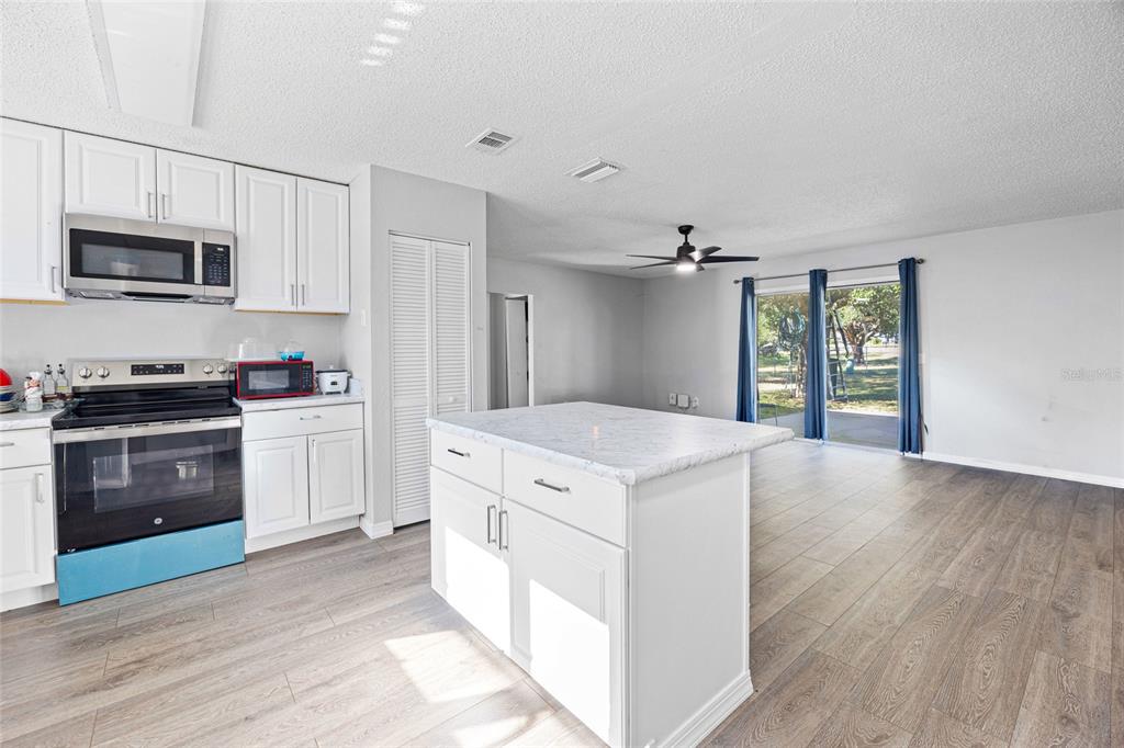 2 Oak Court Pass Ocala, FL 34472 - Photo 4 of 28 a kitchen with stainless steel appliances a white stove top oven and sink