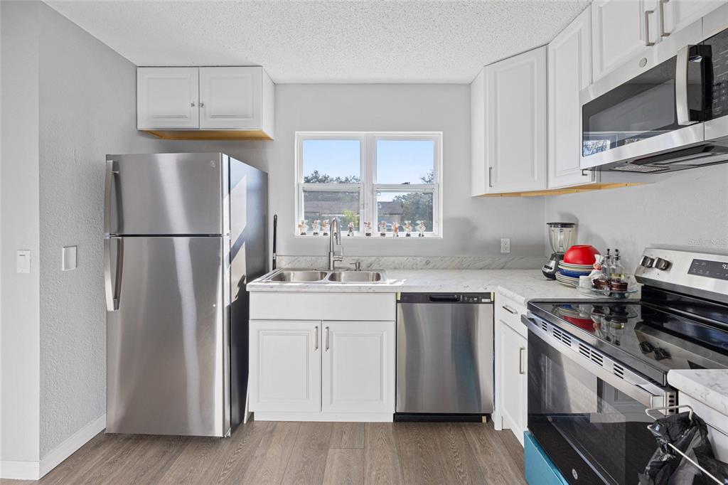 2 Oak Court Pass Ocala, FL 34472 - Photo 6 of 28 a kitchen with appliances a sink cabinets and a window