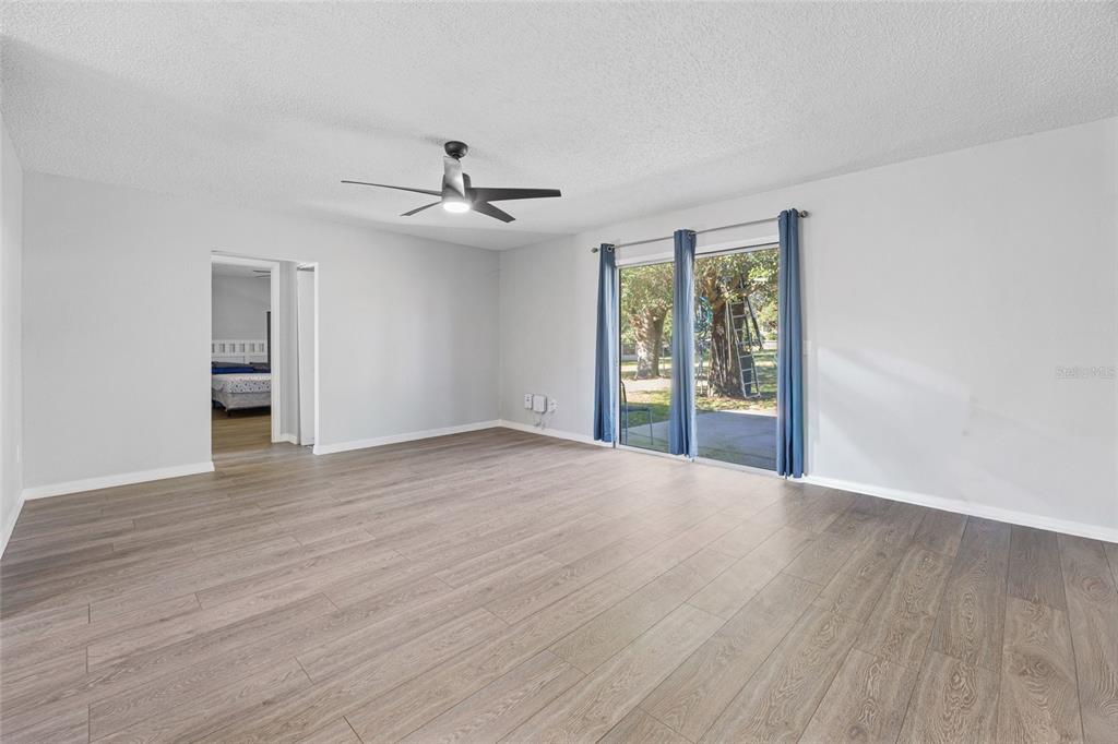 2 Oak Court Pass Ocala, FL 34472 - Photo 8 of 28 a view of an empty room with a window and wooden floor
