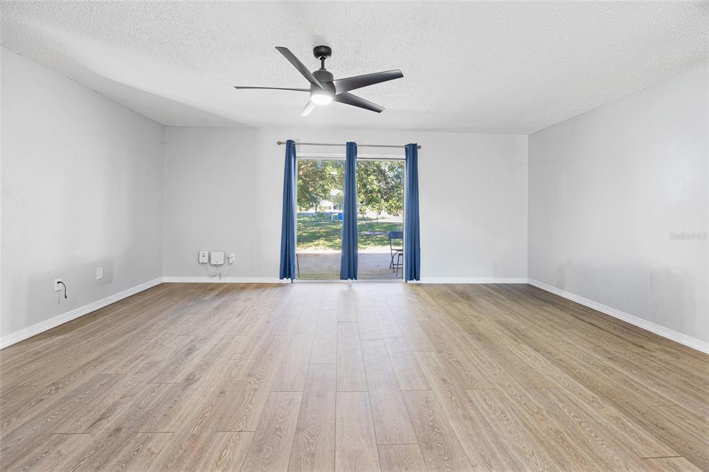 2 Oak Court Pass Ocala, FL 34472 - Photo 9 of 28 an empty room with wooden floor fan and windows