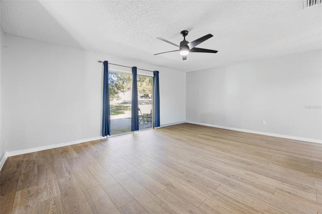 2 Oak Court Pass Ocala, FL 34472 - Photo 10 of 28 an empty room with wooden floor fan and windows