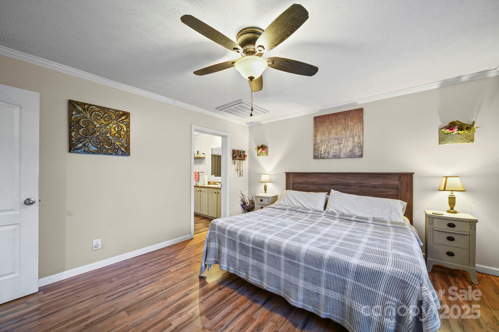 30291 C Red Hill Road Albemarle, NC 28001 - Photo 18 of 45 a bedroom with a large bed and a chandelier