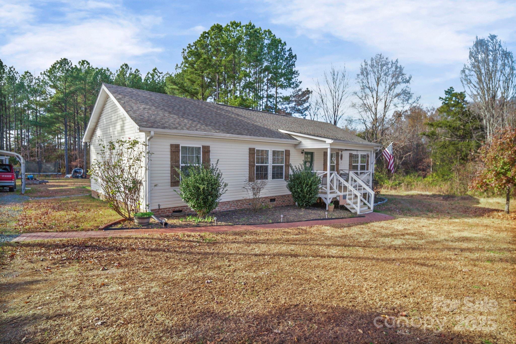 30291 C Red Hill Road Albemarle, NC 28001 - Photo 3 of 45 a view of a house with a yard and large tree