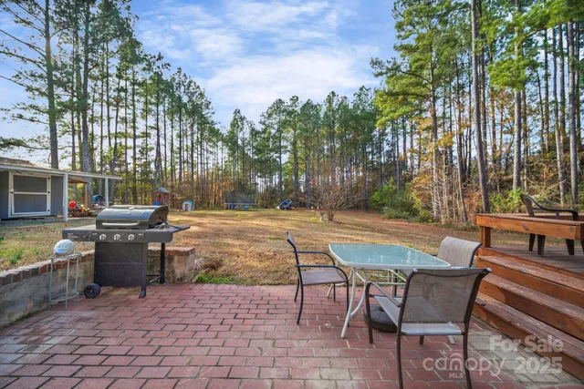 a view of a patio with swimming pool and sitting area
