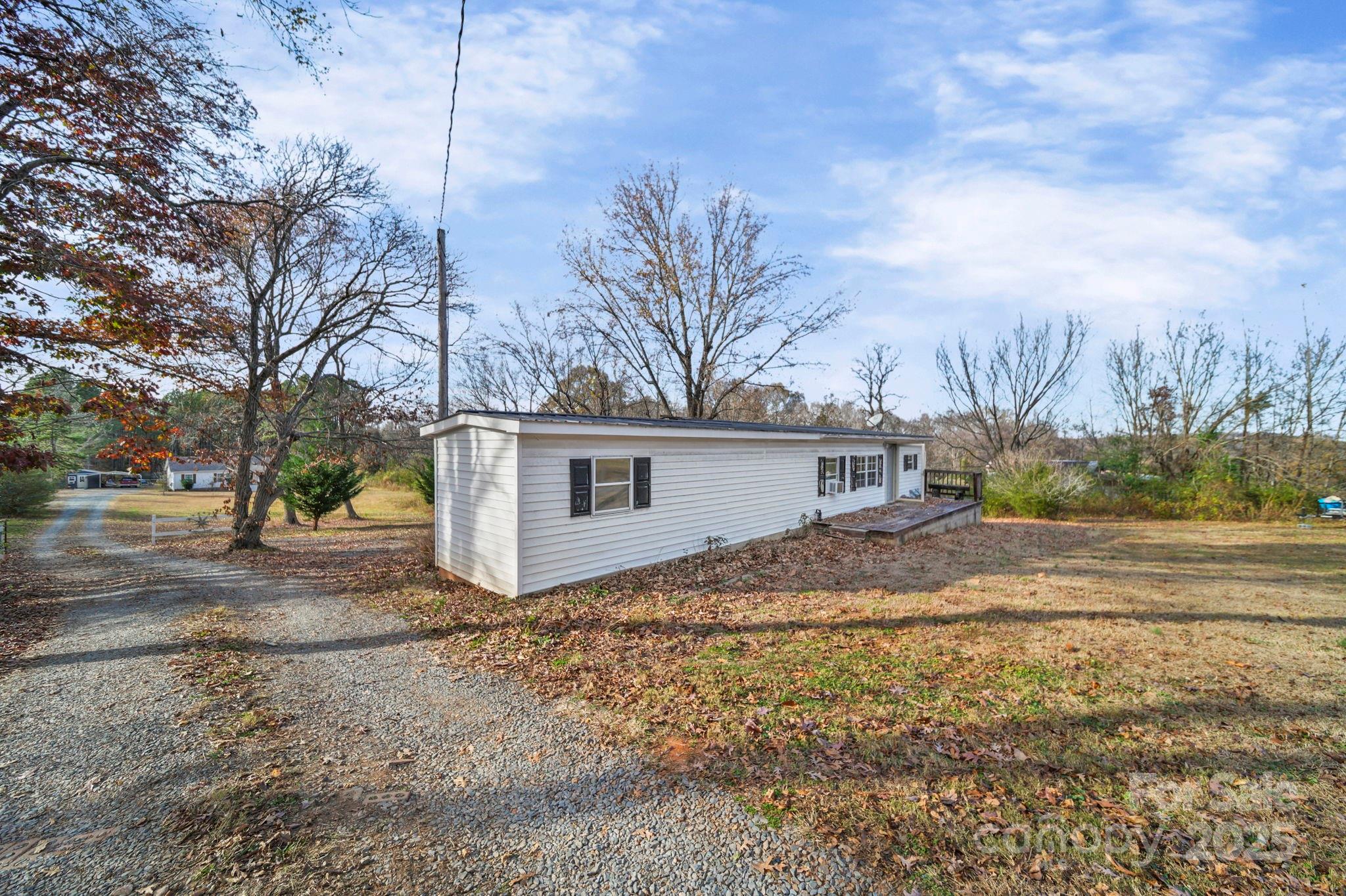 30291 C Red Hill Road Albemarle, NC 28001 - Photo 37 of 45 a view of a house with a yard covered in the forest