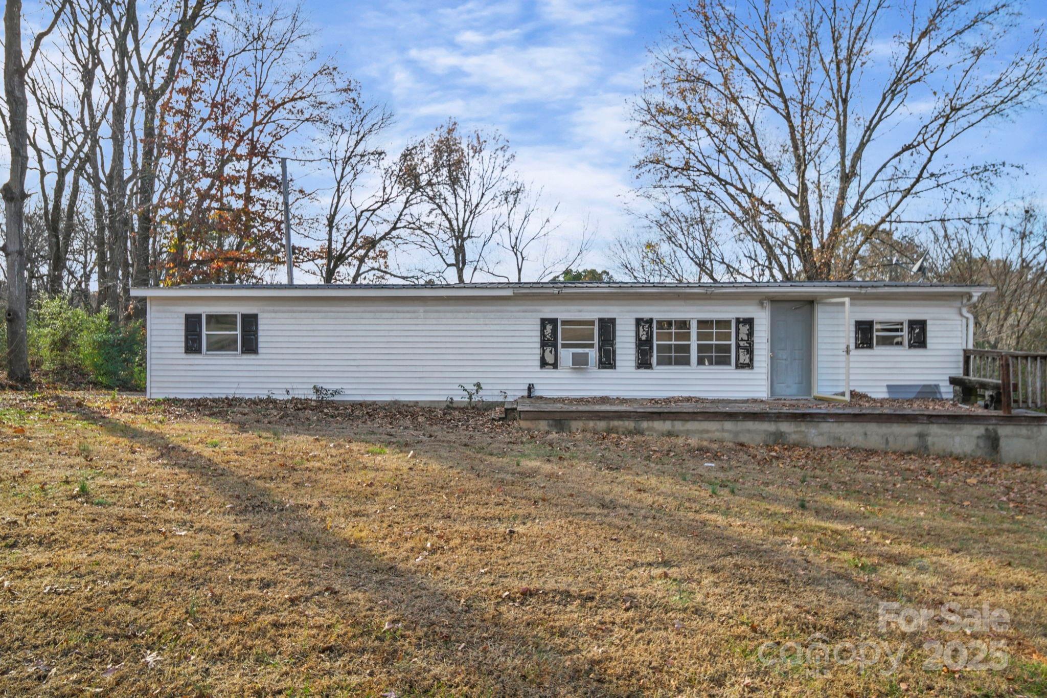 30291 C Red Hill Road Albemarle, NC 28001 - Photo 38 of 45 a backyard of a house with large trees and barbeque oven