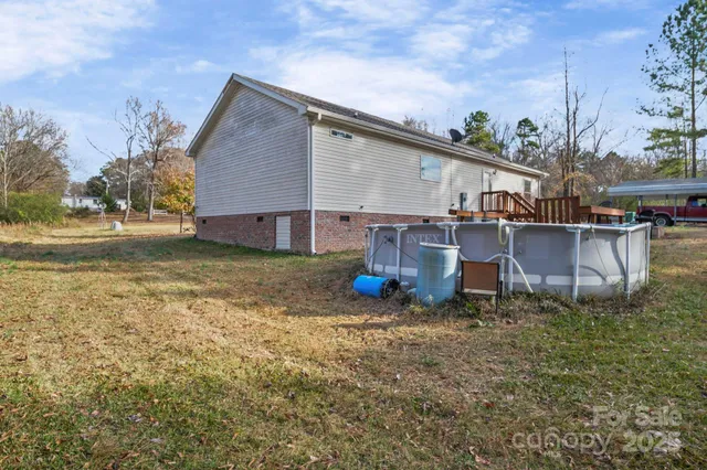 a view of a house with backyard porch and sitting area