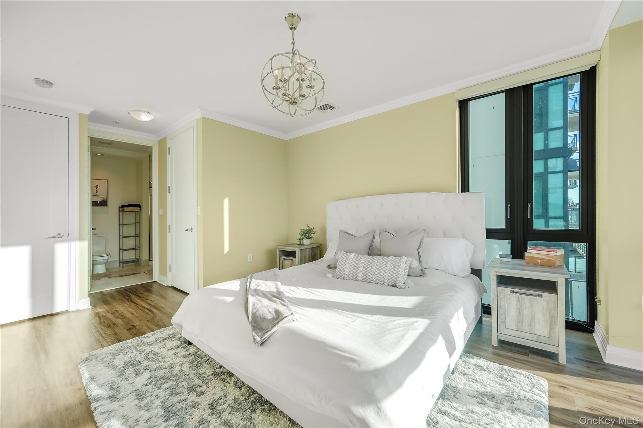 701 Ridge Hill Boulevard, Unit 5B Yonkers, NY 10710 - Photo 3 of 15 Main Bedroom featuring LVP floors and en suite bath
