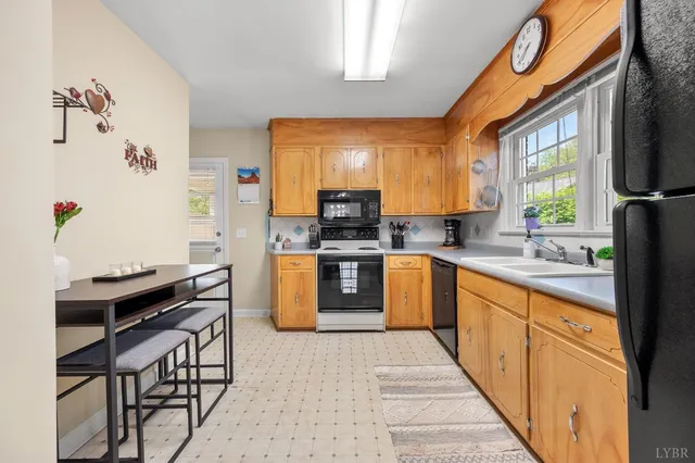 a kitchen with stainless steel appliances kitchen island granite countertop a stove a sink and a microwave