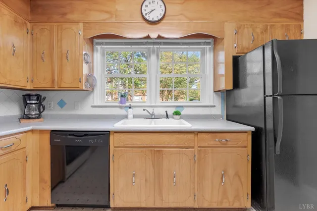 a kitchen with stainless steel appliances granite countertop a sink a refrigerator and a stove