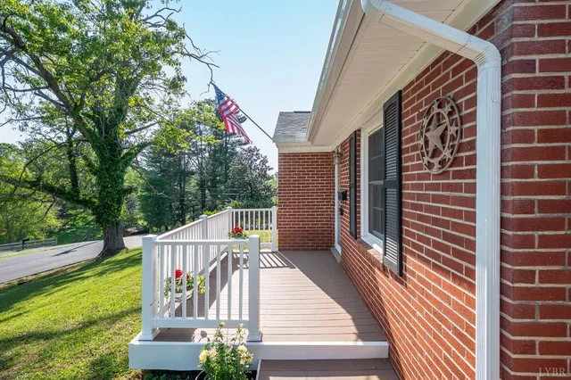 a view of balcony with wooden floor and fence