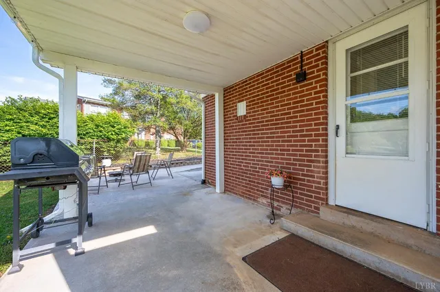 a view of a porch with chairs and potted plants