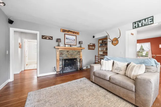 a living room with furniture and a fireplace