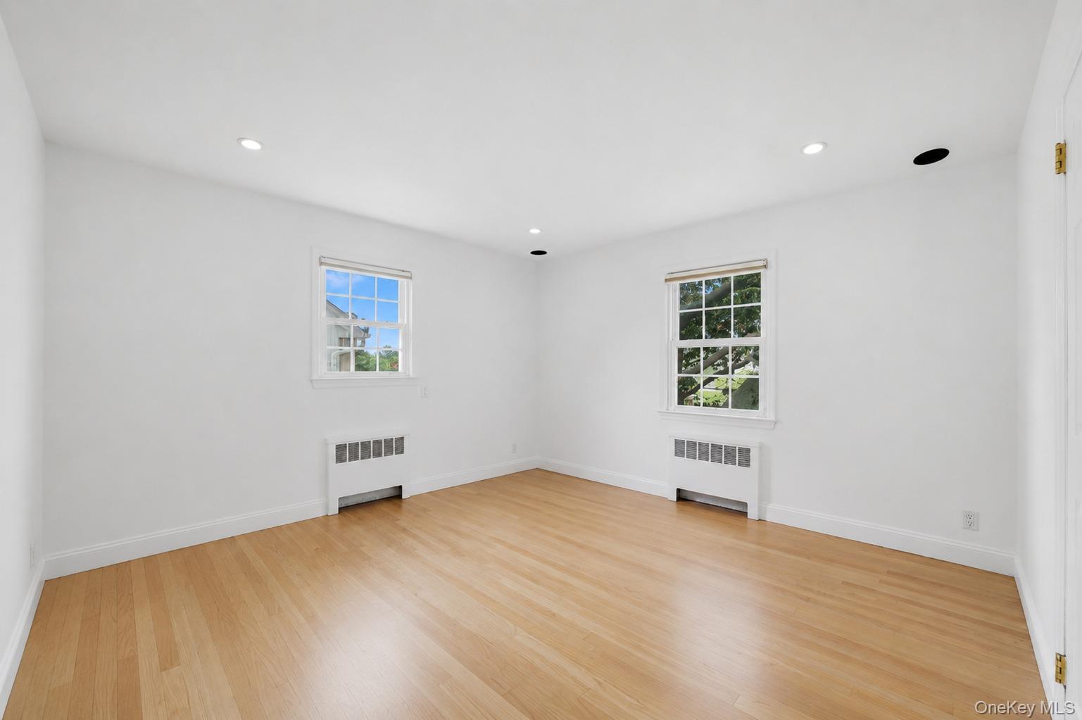 144 Bell Road Scarsdale, NY 10583 - Photo 25 of 49 Spacious 2nd bedroom with light wood-finish flooring, white walls, and two windows providing natural illumination