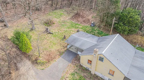 an aerial view of a house with a yard