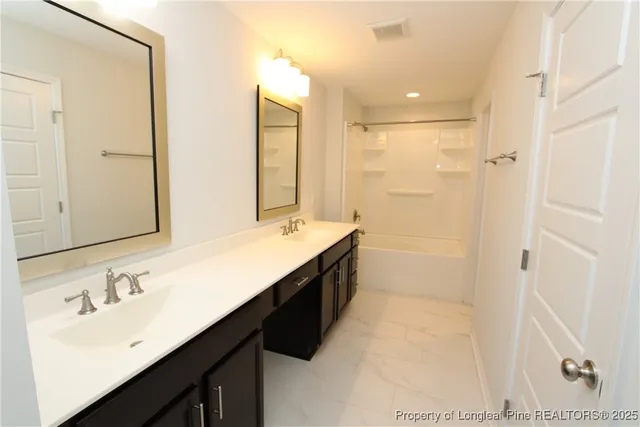a bathroom with a double vanity sink mirror and