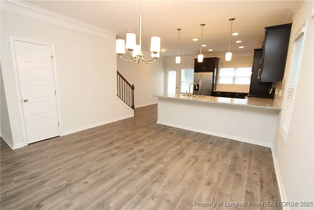 a view of kitchen and hall with wooden floor