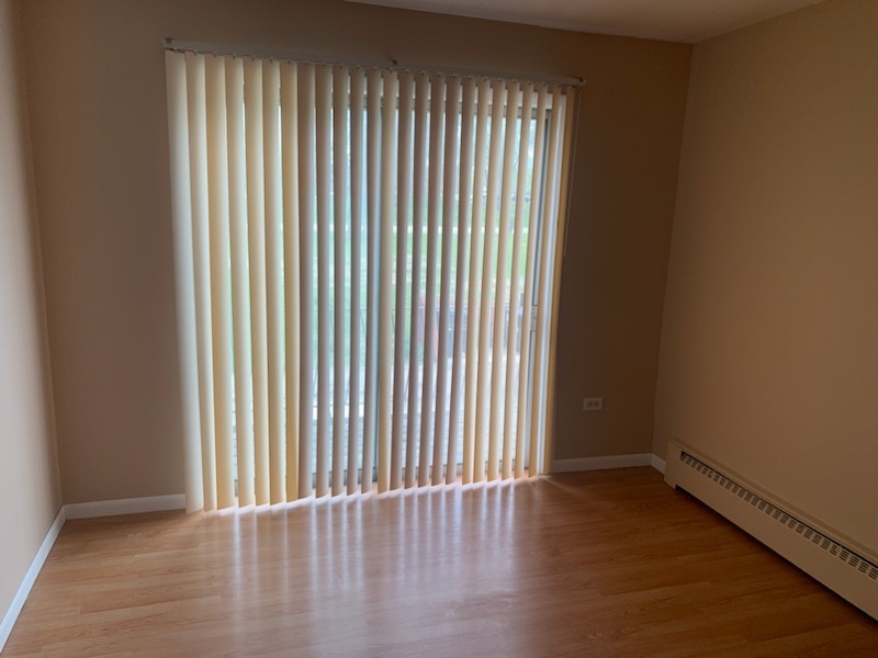 239 Northway Park Road, Unit 12 Machesney Park, IL 61115 - Photo 14 of 15 an empty room with wooden floor and windows
